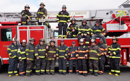 Firefighters standing in front of fire truck